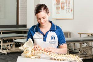 university of melbourne physiotherapy student with skeletal model