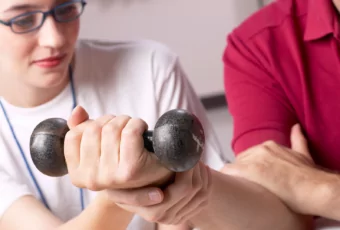 occupational therapist working with client to strengthen wrist