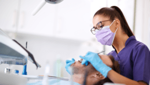 young female dentist working with patient