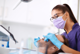 young female dentist working with patient