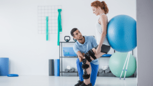 physiotherapist working with patient with ball