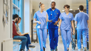 Australian medical programs Medical students wearing scrubs walking in hospital hallway