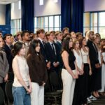 law students standing in auditorium