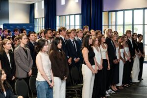 law students standing in auditorium