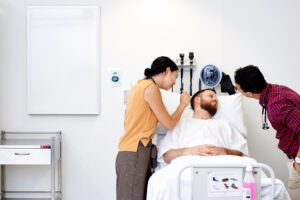 Learn more about studying medicine at Deakin Medical School medical students examining a patient lying in hospital bed