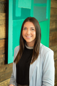 Learn more about studying law at Bond Law School headshot of woman standing in front of green sign